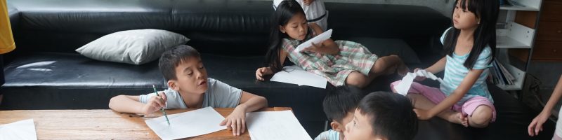 Children making paper airplanes